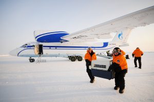 dog box being offloaded from private plane at the North Pole